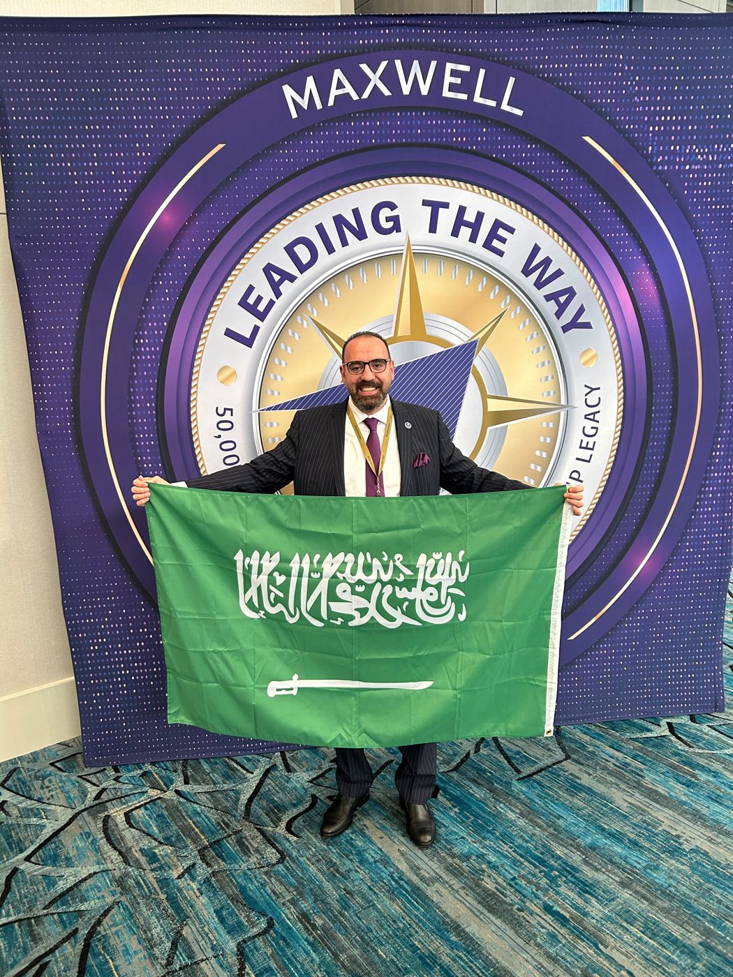 Carrying the Saudi flag, International Maxwell Conference